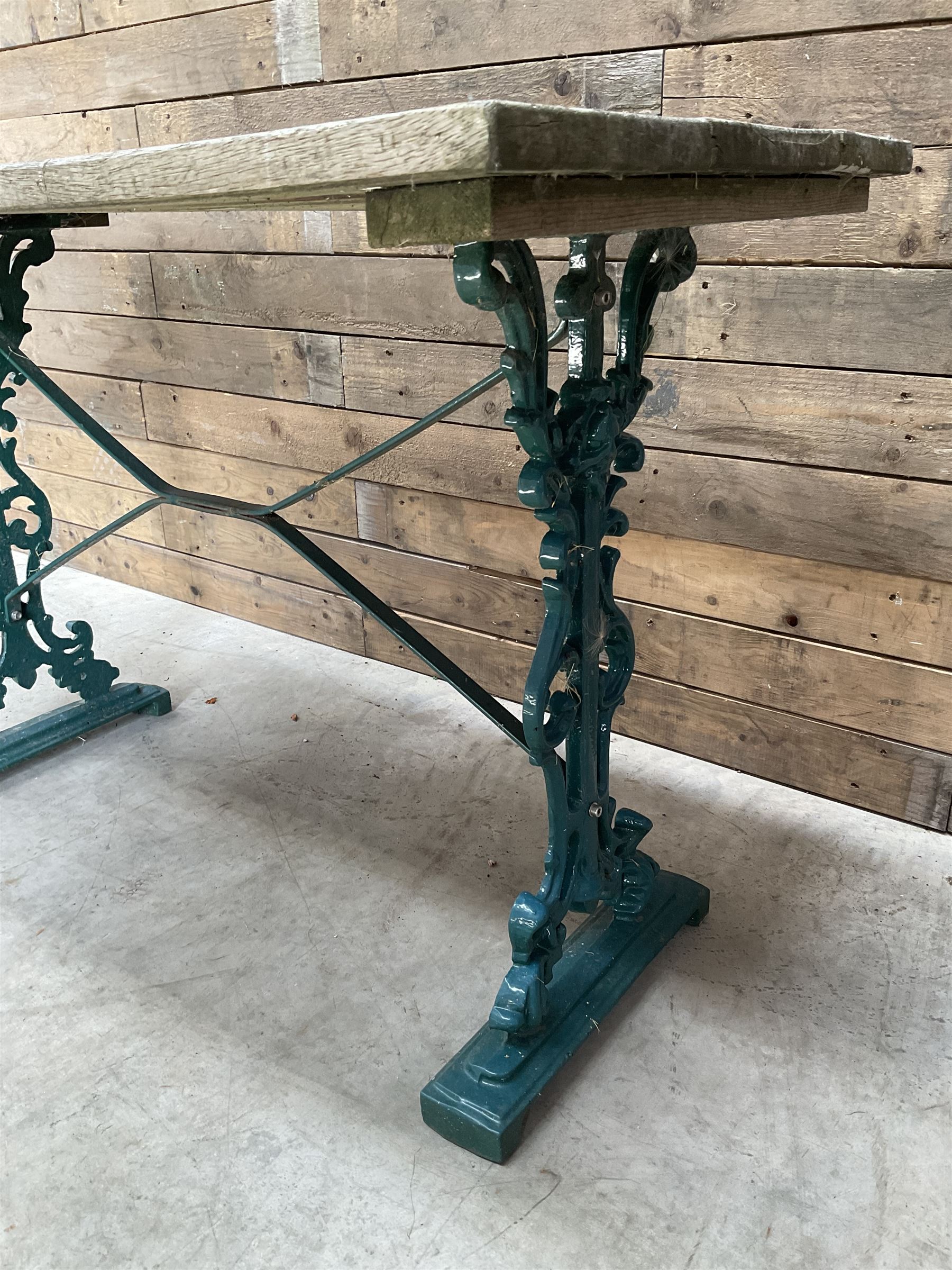 Early 20th century green painted ornate cast iron garden table, wood slatted top