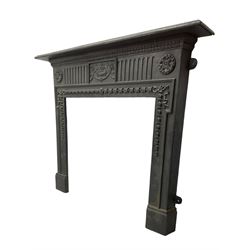 Adam design - cast iron fire surround, moulded rectangular mantel over central foliate urn and vertical flutes, flanked by C-scroll floral roundels, the aperture decorated with trailing bellflowers
