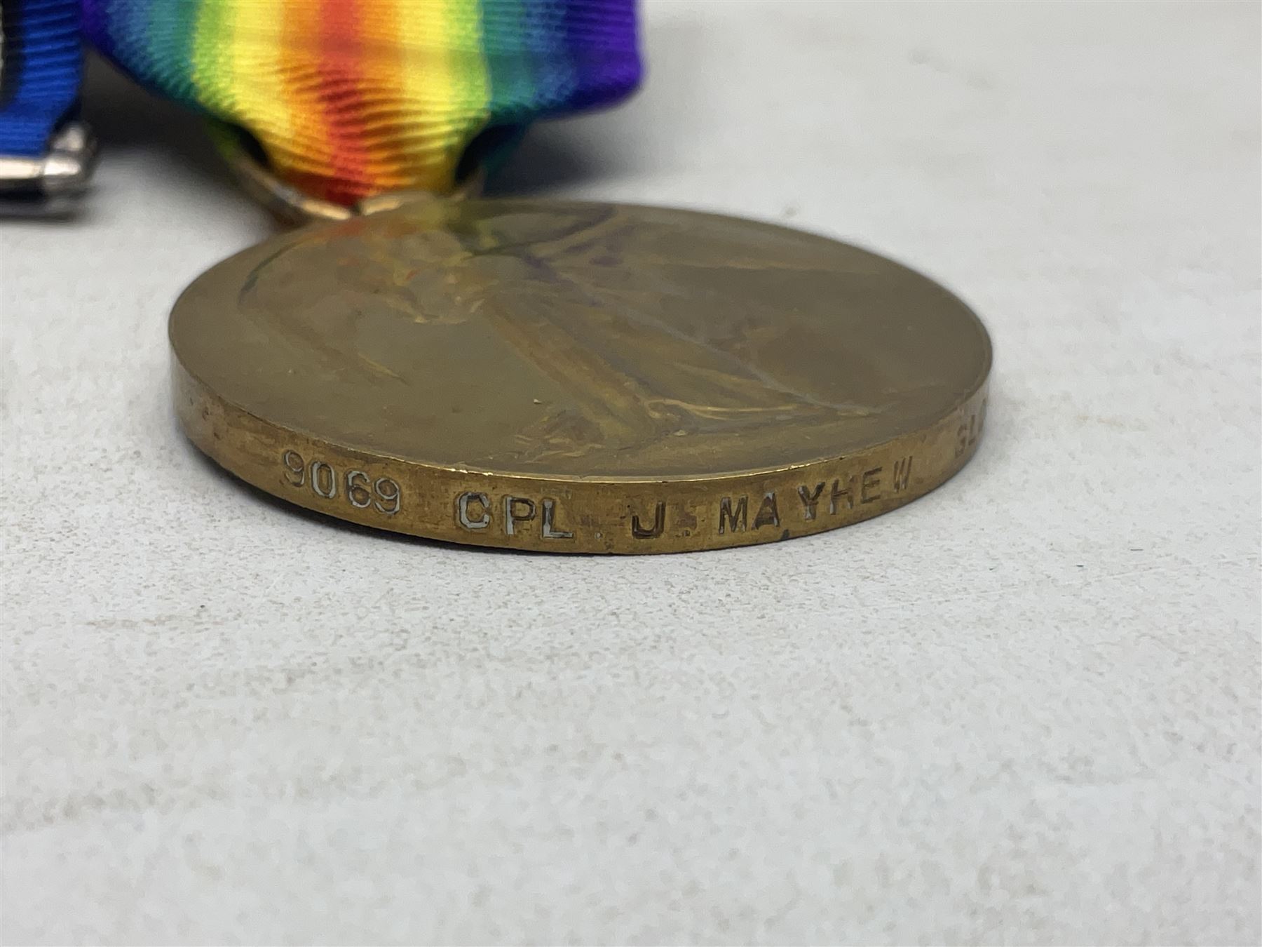 WW1 KIA group of three medals comprising British War Medal, 1914-15 Star and Victory Medal awarded to 9069 Cpl. J. Mayhew Glouc. R.; with ribbons; displayed on modern bar, and photograph of recipient in uniform; some biographical details