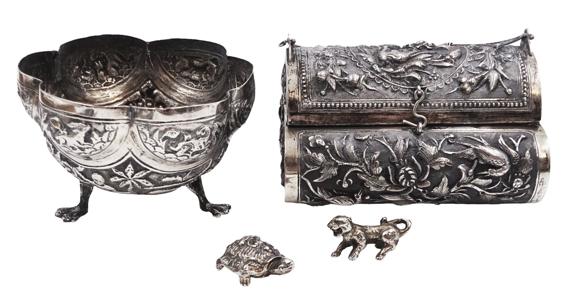 Continental silver bowl, of circular lobed form, repousse decorated with tribal and hunting scenes, upon three claw feet, unmarked but testing as 800 silver, H5cm, together with Chinese silver purse, of domed rectangular form, with ornate repousse decoration, depicting flowers, instruments, birds etc, with lobed wire wrapped handle, with Chinese character marks beneath, testing 650 silver,  including handle H11cm, and two base metal miniature animals