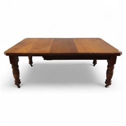 Victorian mahogany extending dining table, rectangular top with chamfered corners above a plain frieze raised on turned reeded legs with castors and two additional leaves, 197cm fully extended, and a set of six early 20th century oak upholstered chairs with drop-in seats, arched panelled back splat and close studded border on turned front legs joined by stretchers, 47x41x109cm 