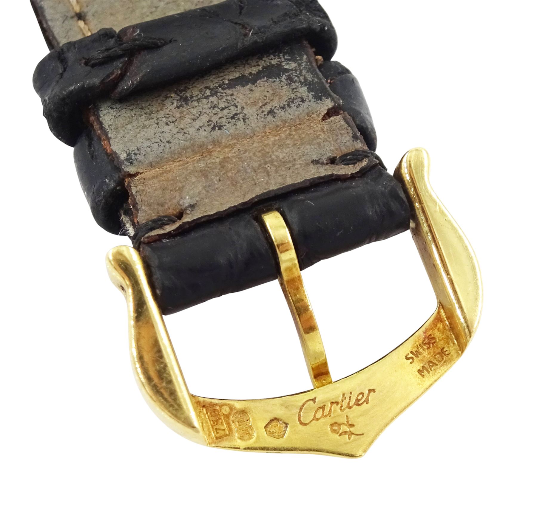 Cartier Tank ladies 18ct gold quartz wristwatch, back case No. M 21001496, white dial with Roman numeral hour markers, on black leather strap with 18ct gold buckle, both by Cartier, hallmarked