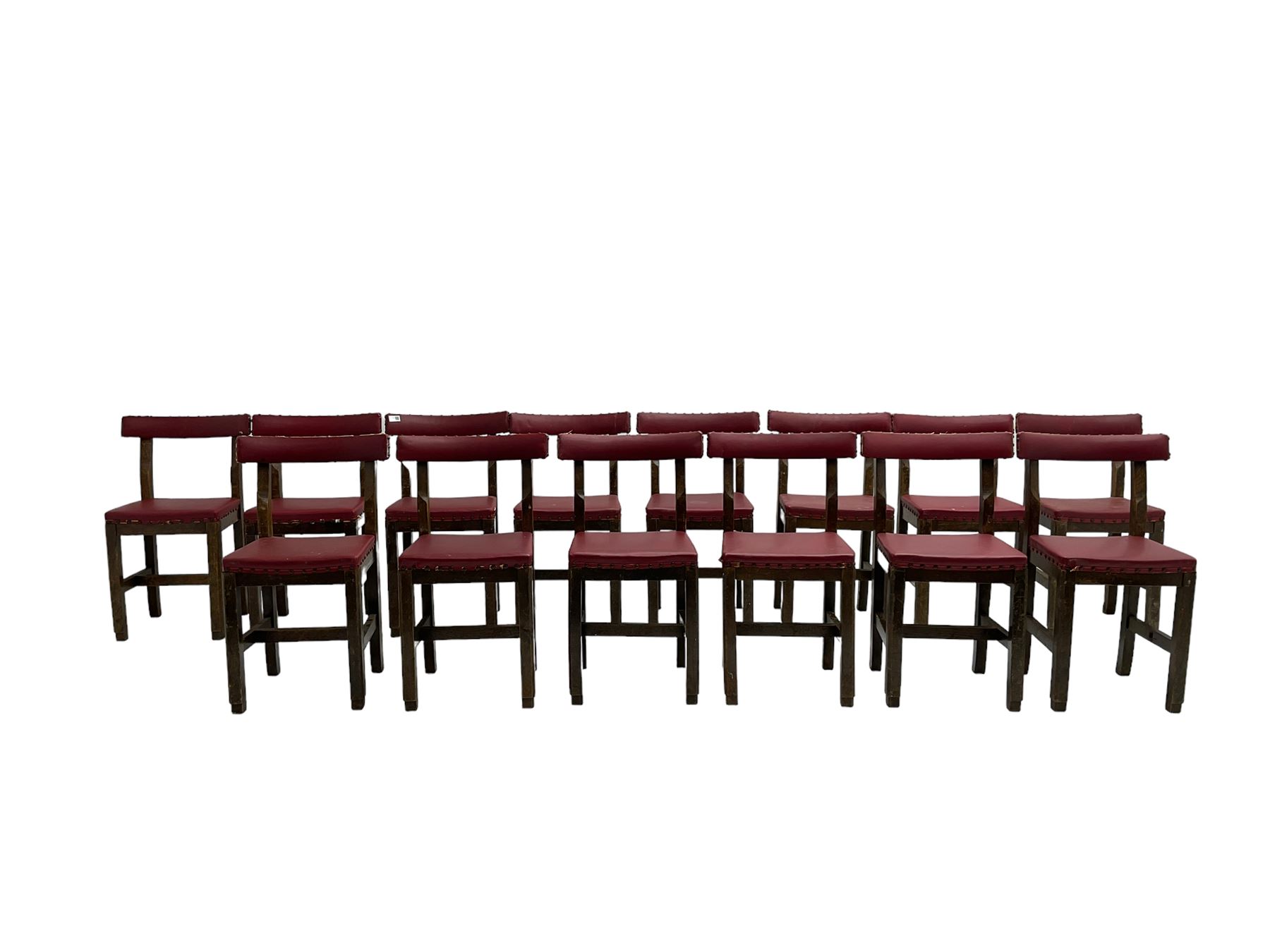 Set fifteen early 20th century oak school chairs, back rail and seat upholstered in claret red faux leather with studwork, raised on square supports united by H-stretcher (15)