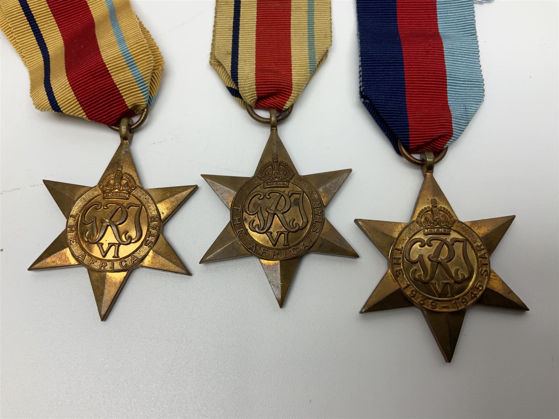 Ten WW2 medals comprising two 1939-1945 war medals, two Defence medals, two 1939-1945 Stars, two Africa Stars, France & Germany Star and Burma Star; together with bar of four miniature medals; all with ribbons