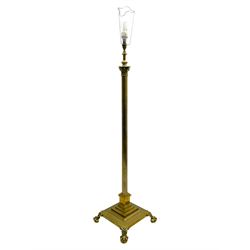 Late 20th century brass telescopic standard lamp in the form of a Corinthian column, Corinthian acanthus leaf capital over reeded shaft, stepped and moulded square base with four extending ball and claw feet