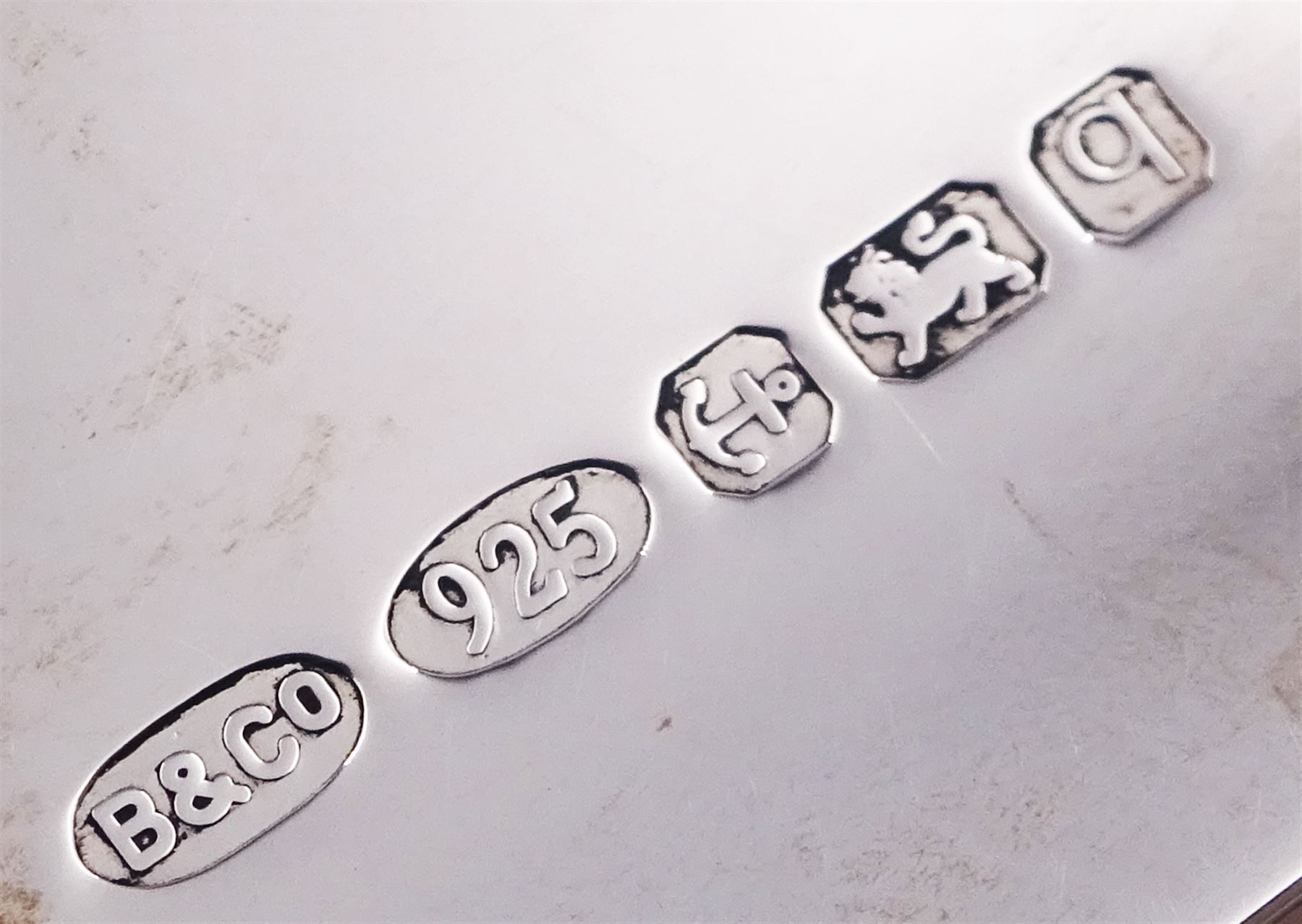 Modern silver letter opener with ring terminal, hallmarked Francis Howard Ltd, Sheffield 1977, L21.3cm, together with a modern silver money clip, of plain typical form, hallmarked W I Broadway & Co, Birmingham 2015, L5cm, each with maker's box, approximate total silver weight 2.45 ozt (76.2 grams)