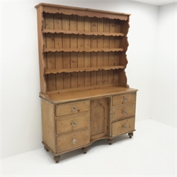 Victorian and later pine dresser, raised three tier plate rack, six graduating drawers flanking single cupboard, turned supports, W146cm, H196cm, D47cm