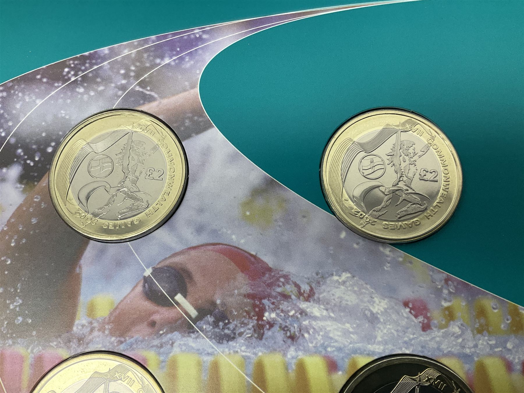 The Royal Mint Queen Elizabeth II 2002 Manchester Commonwealth Games four coin two pound coin  set in card display