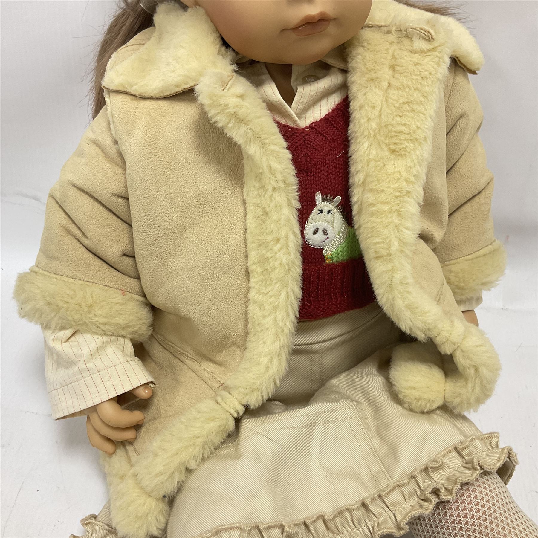 Two Zapf Creation limited edition designer collection dolls, by Brigette Paetsch, the first example with faux suede jacket, red jumper and denim skirt, no. 460, the second example 'Linda' in white dress with teddy bear accessory, no. 785, each signed B Paetsch, tallest L60cm