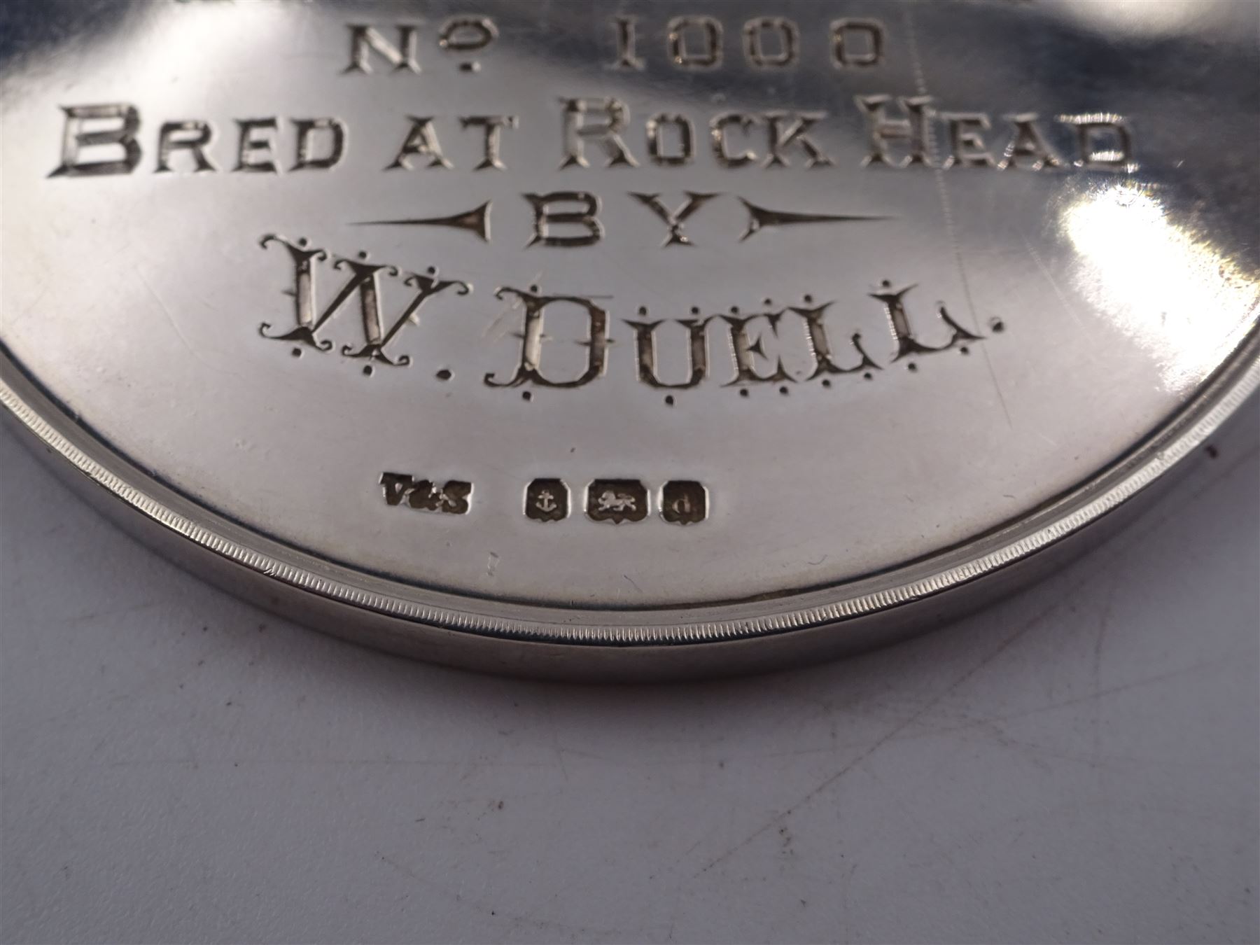 Edwardian silver medal, of circular form, embossed to front with a bay horse and inscribed Cleveland Bay Horse Society, engraved verso 1904 Egton Show won by Rock Dove No 1000 bred at Rock Head by W Duell, hallmarked Vaughton & Sons, Birmingham 1903, contained within fitted case, D6.3cm