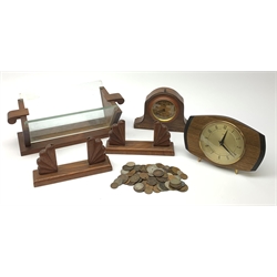 An early 20th century French mantel clock; 1960s mantel clock; Art Deco style walnut and plate glass book trough; two photograph stands; and quantity of coins.