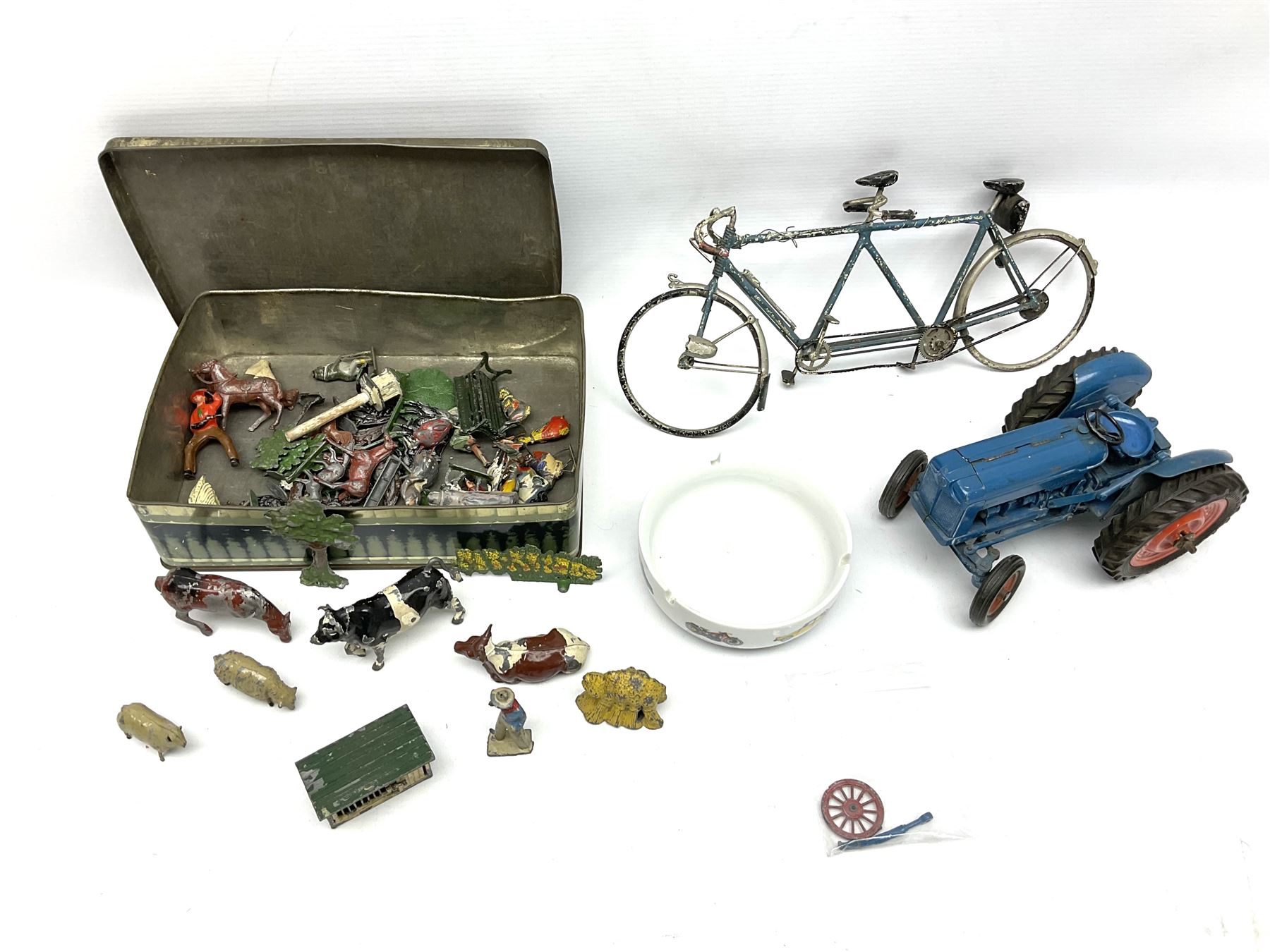 Chad Valley clockwork Fordson Major Tractor, a group of play worn Britains and other lead and metal farm animals, figures and accessories including a kennel, haystacks, dovecote, cows, sheep etc, together with a diecast model of a Tandem Bike L31cm
