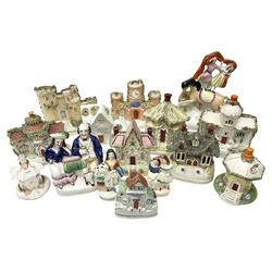 Collection of 19th century and later Staffordshire figures, to include a mid 19th century figure group of circus performers upon horseback, figure of a young girl in floral dress with her arm around a black spotted rabbit, other figure groups and quantity of houses, castle and clock tower figure, tallest H22cm (13)