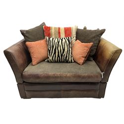 Knole design two-seat snuggler sofa, upholstered in brown leather with scatter cushions upholstered in contrasting striped and zebra print fabric