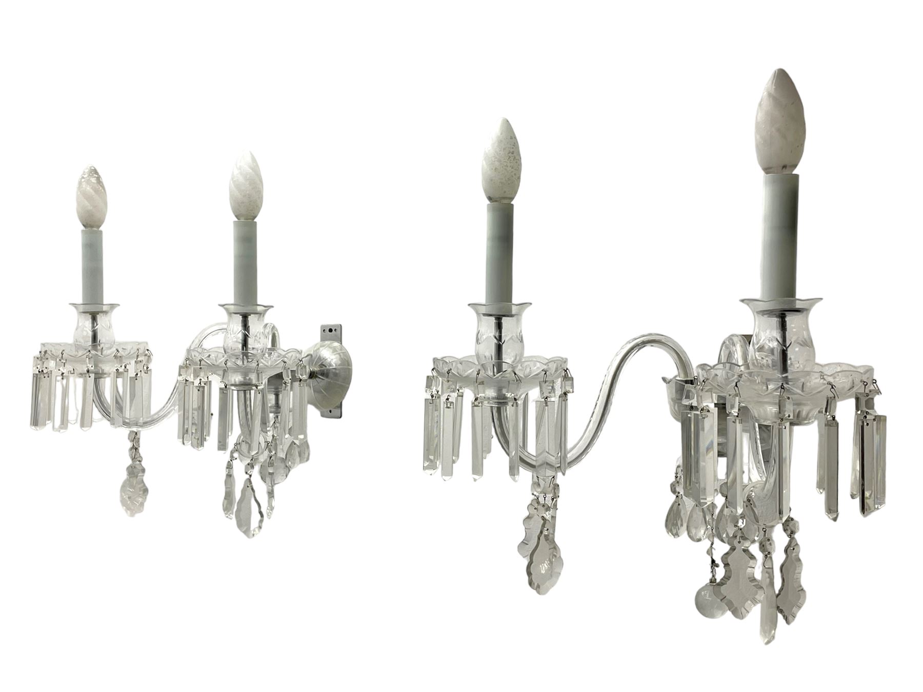 Pair of cut glass two branch wall sconce candelabras, each with S scroll extending branches with shaped and bevelled circular drip trays, hung with pendant drops