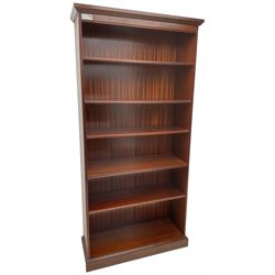 Tall mahogany open bookcase, moulded cornice over one fixed shelf and four adjustable shelves, on plinth base