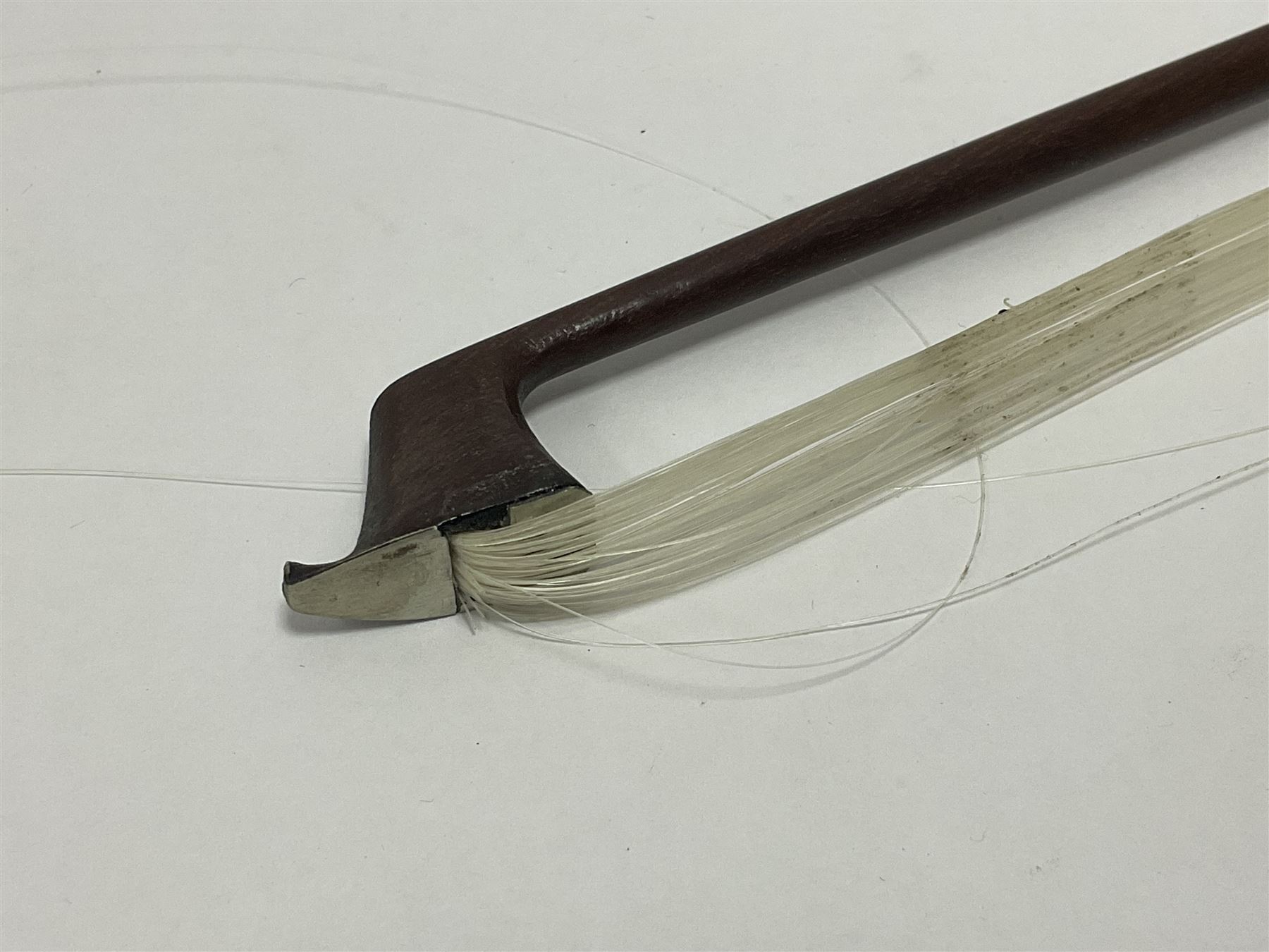 19th century wooden violin bow with a decorative mother of pearl inlay depicting flowers to the frog, with a bone adjuster screw