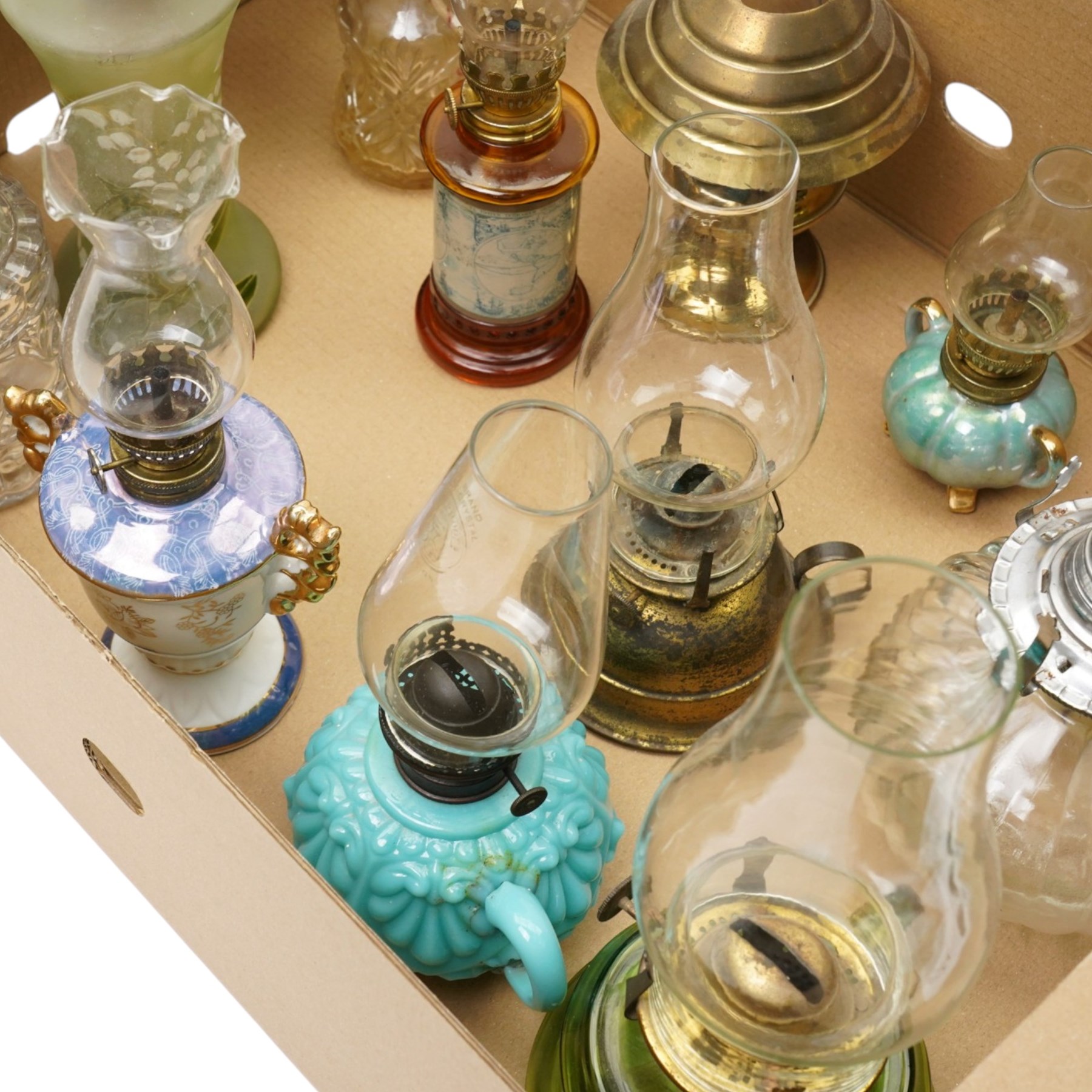 Small table oil lamp with painted glass base and various other small glass and ceramic oil lamps