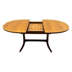 G-Plan - mid-20th century teak extending dining table, oval top with concealed central butterfly leaf extension, raised on splayed supports with cross-stretcher; three dining chairs with curved top rail and vertical splats