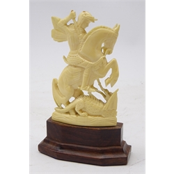  Early 20th century carved ivory figure of Saint George and the Dragon on hardwood stand, H13cm   