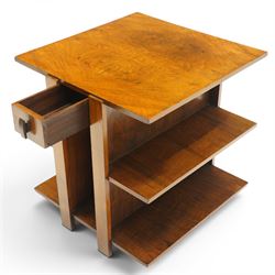 Art Deco walnut coffee table, square book-matched veneered top over single frieze drawer with brass handle, flanked by open side shelves, raised on rectangular end supports