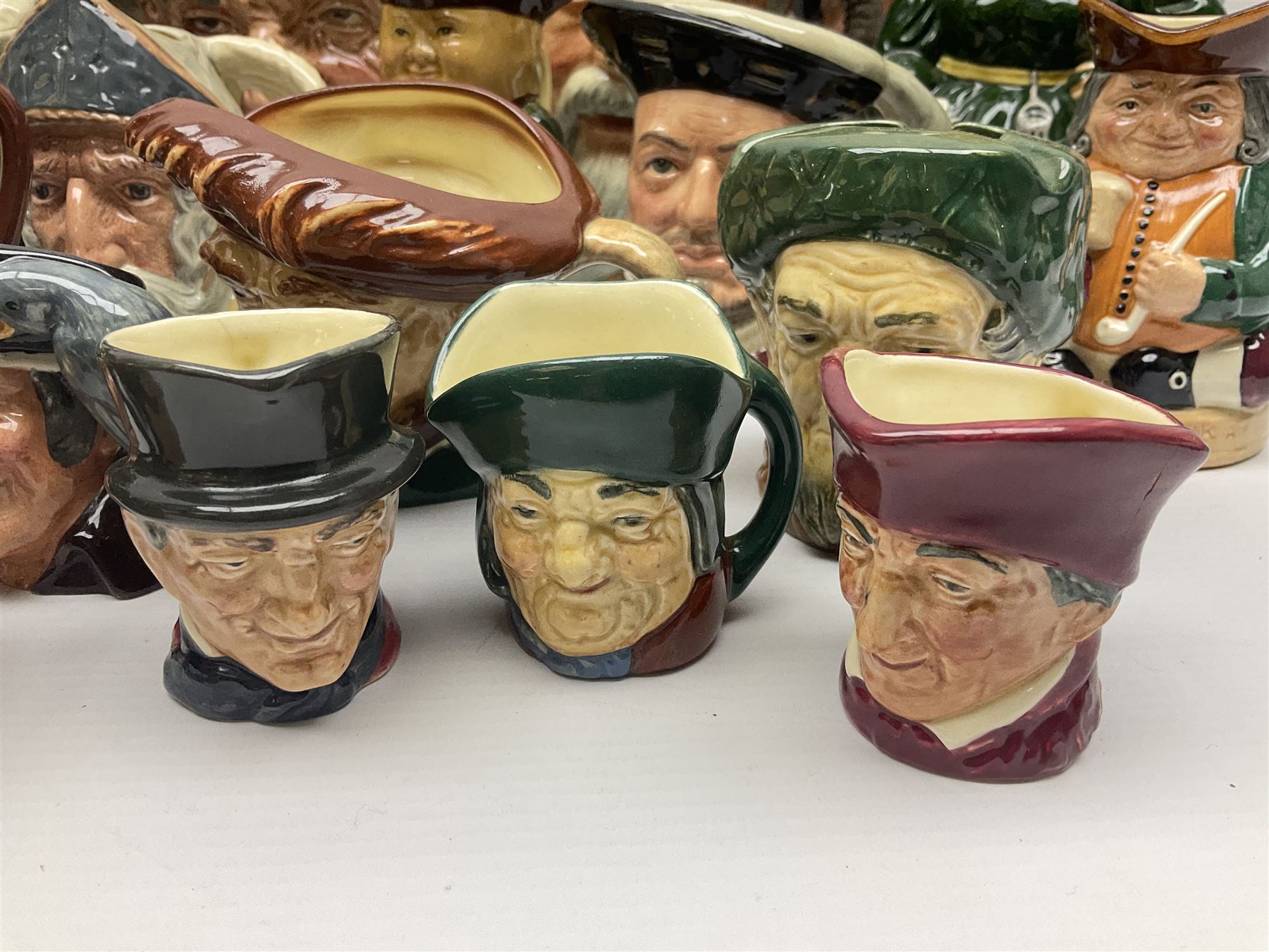 Large collection of Royal Doulton character jugs, to include Robinson Crusoe D6532, Tam O Shanter D6632, The Falconer D6533 etc, together with similar charater jugs and toby jugs   