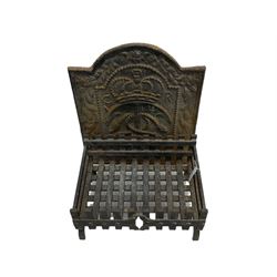 Ornate cast iron fire back with crown, and dog grate
