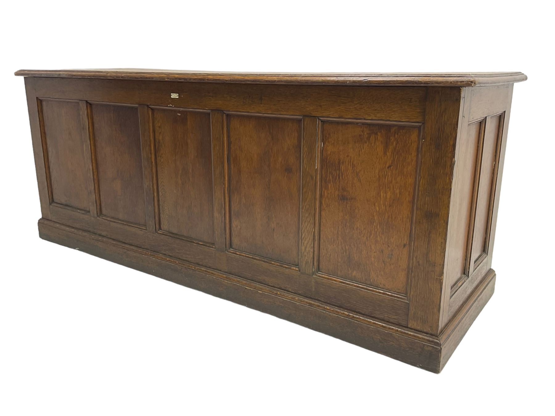 Illingworth Ingham and Co. School Furnishers (Leeds c1900) - early 20th century oak rostrum or headmaster's desk, rectangular top, the front and sides panelled with open reverse, on plinth base
