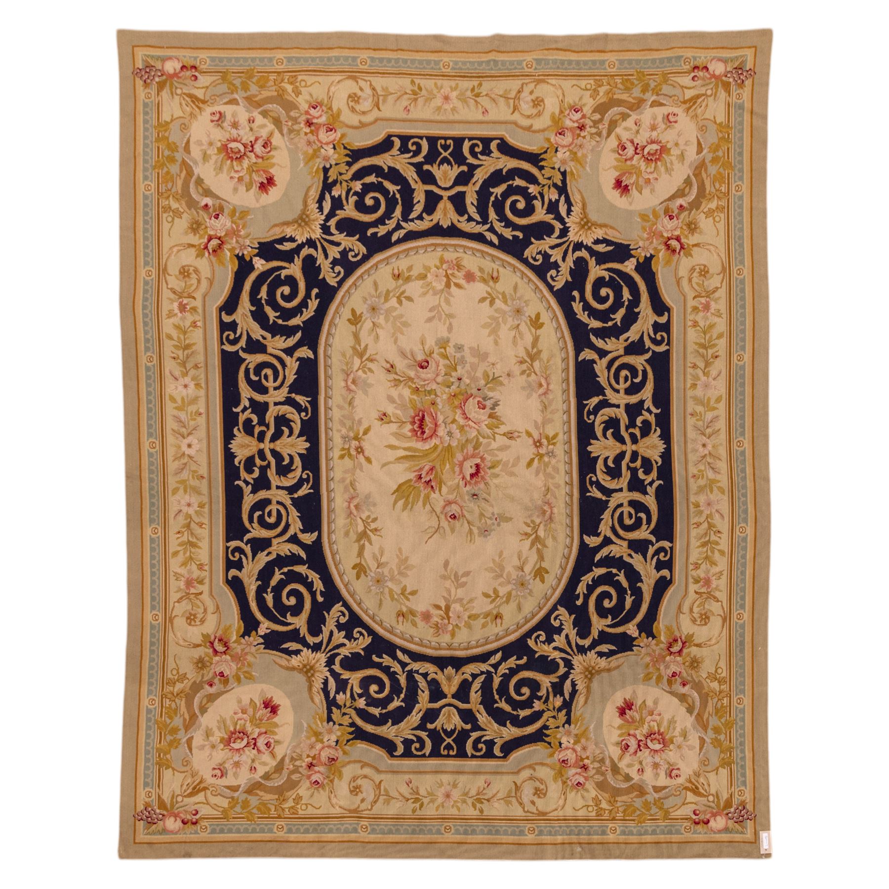 20th-century Aubusson-style woven tapestry wall hanging of rectangular form, the design with a central oval floral medallion composed of delicate sprays in soft pinks, creams, and muted green enclosed by an elaborate dark blue scrolling acanthus ground enriched with foliate ornamentation, field framed by floral cartouches to the corners and multiple guard borders in pale blue, ivory, and ochre tones