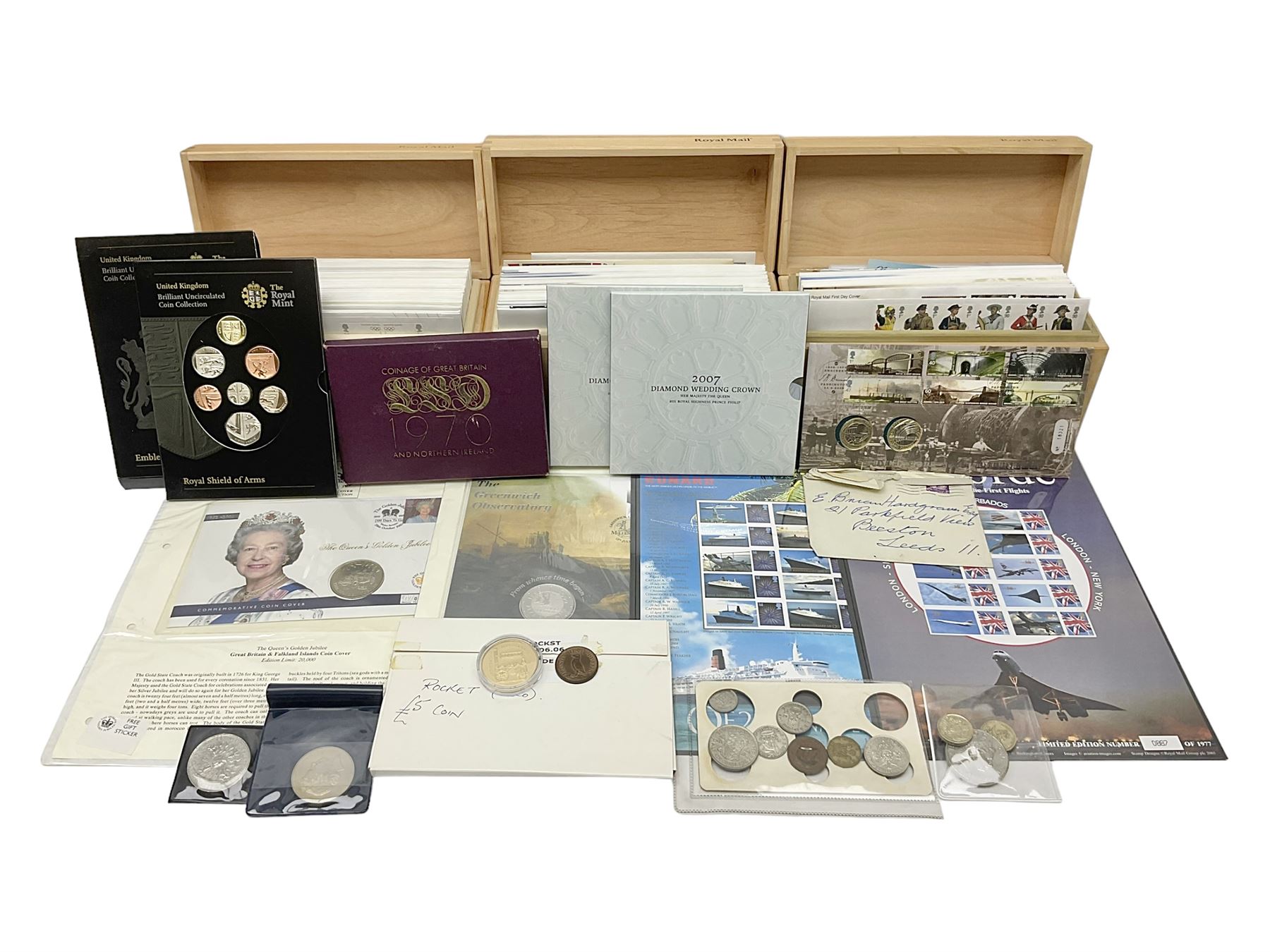 Coins and stamps, including The Royal Mint Great Britain 1970 coin set in plastic holder, 2006 'Brunel' coin cover containing two commemorative two pound coins, Alderney 2006 sterling silver proof five pounds, two 2007 five pound coins in card folders, two limited edition mint first class stamp sheets each comprised of ten first class stamps, various first day covers many with special postmarks housed in 'Royal Mail' boxes etc