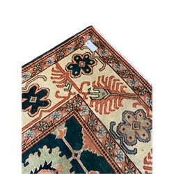 Persian emerald green ground rug, the field decorated with large stylised plant motifs, ivory ground border with repeating leaf motifs, the guards decorated with trailing branch and flowerhead motifs