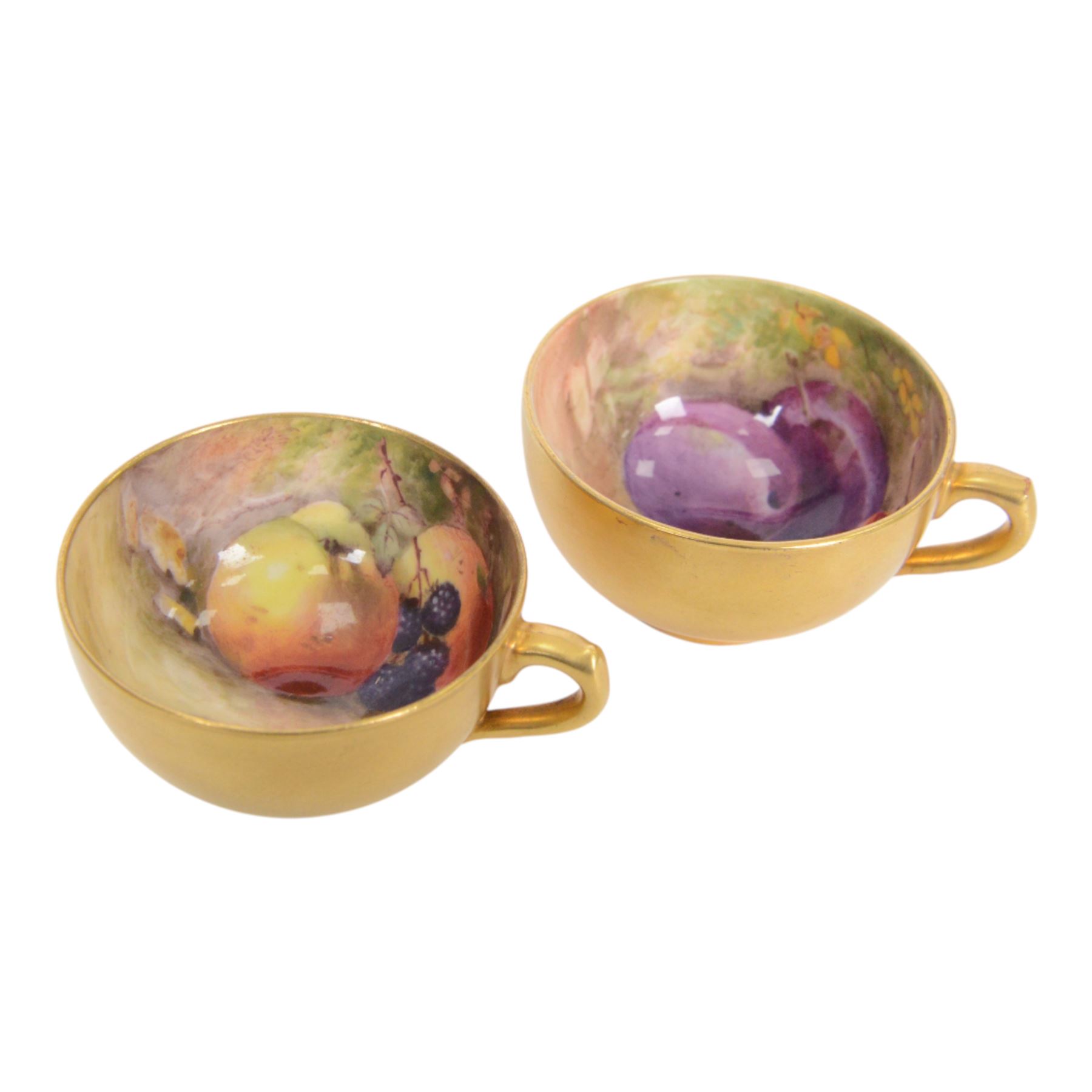 Two small 20th century Royal Worcester cabinet cups and saucers, together with another saucer, each painted with a still life of fruit upon a mossy ground, bearing various signatures: E Townsend, Ricketts, G H Cole, and H Ayrton, each with puce printed mark beneath, teacups approximately H3cm D5.5cm, coffee cup H4.5cm, saucers 9.5.cm
