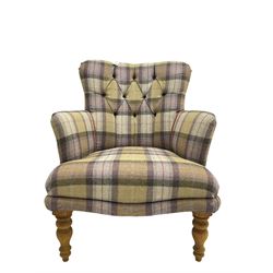 Traditional shaped armchair, upholstered in deep buttoned purple tartan fabric with red piping, raised on turned and tapering stained beech supports