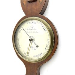 Early 19th century William IV mercury wheel barometer with a rosette inlaid broken pediment and correspondingly inlaid round base, mahogany veneered case with inlaid oval conch shell paterae and satinwood stringing to the edge, with an arched thermometer box and spirit thermometer measuring degrees Fahrenheit from 20 to 120, eight-inch silvered register reading barometric pressure in inches from 28  to 31, with predictions in Roman upper and lower case and script, dial inscribed “A Tagliabue,24 Grenville Street, Luther Lane, London”, with a steel indicating hand, brass recording hand and cast brass bezel.
