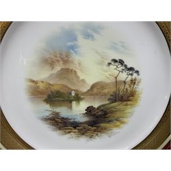 Early 20th century Coalport cabinet plate, the central reserve finely hand painted with a landscape scene of Kilchurn Castle by Percy Simpson, signed P H Simpson, within ornate gilt border raised with diamond pattern and berry red banding, the reverse with stamped green Coalport England AD 1750 mark, painted Kilchurn Castle 7610/k, and impressed 18H12 80, D27cm