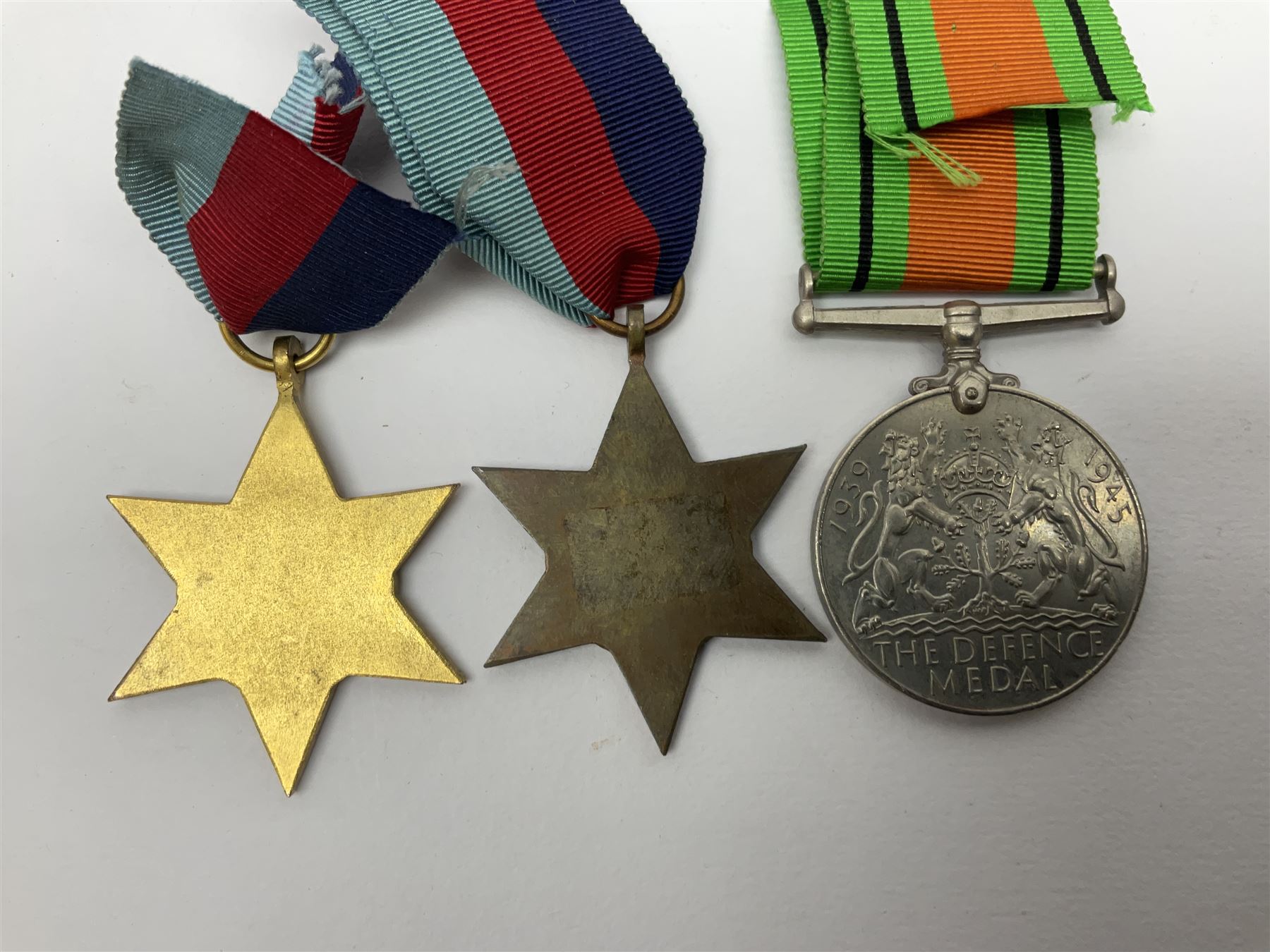 Twelve WW2 medals comprising four 1939-1945 war medals, four Defence medals, three 1939-1945 Stars and Africa Star; all with ribbons; some as groups in two issue boxes with slips