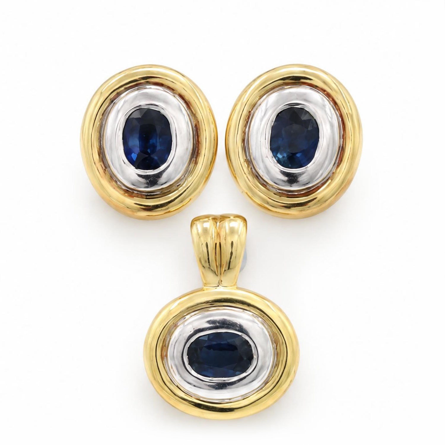 Pair of 14ct gold synthetic sapphire earrings and pendant, each rubover set with a single oval cut sapphire, within a white and yellow gold oval surround