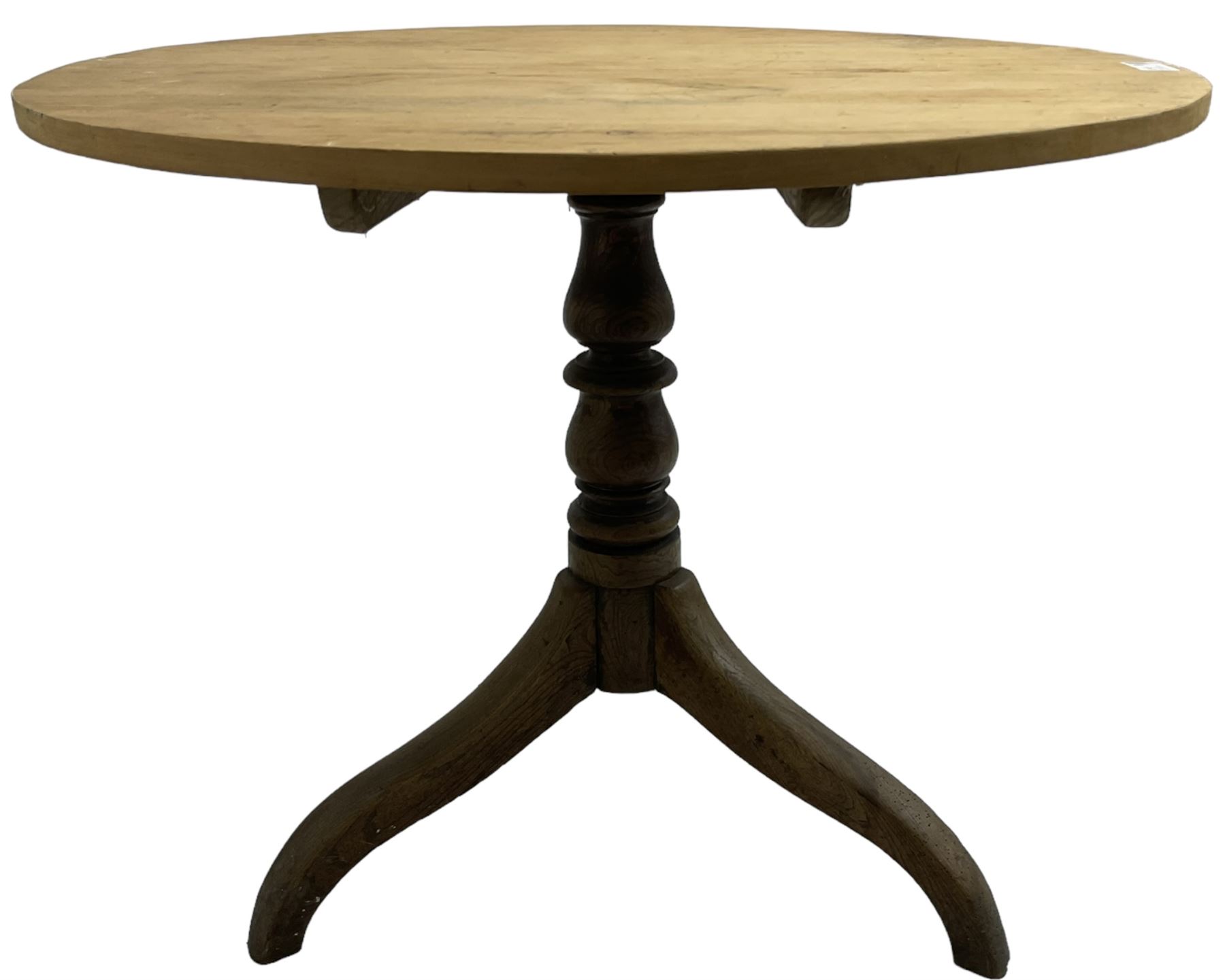 Early 19th century pine and elm tripod table; circular tilt-top over turned column and three splayed supports