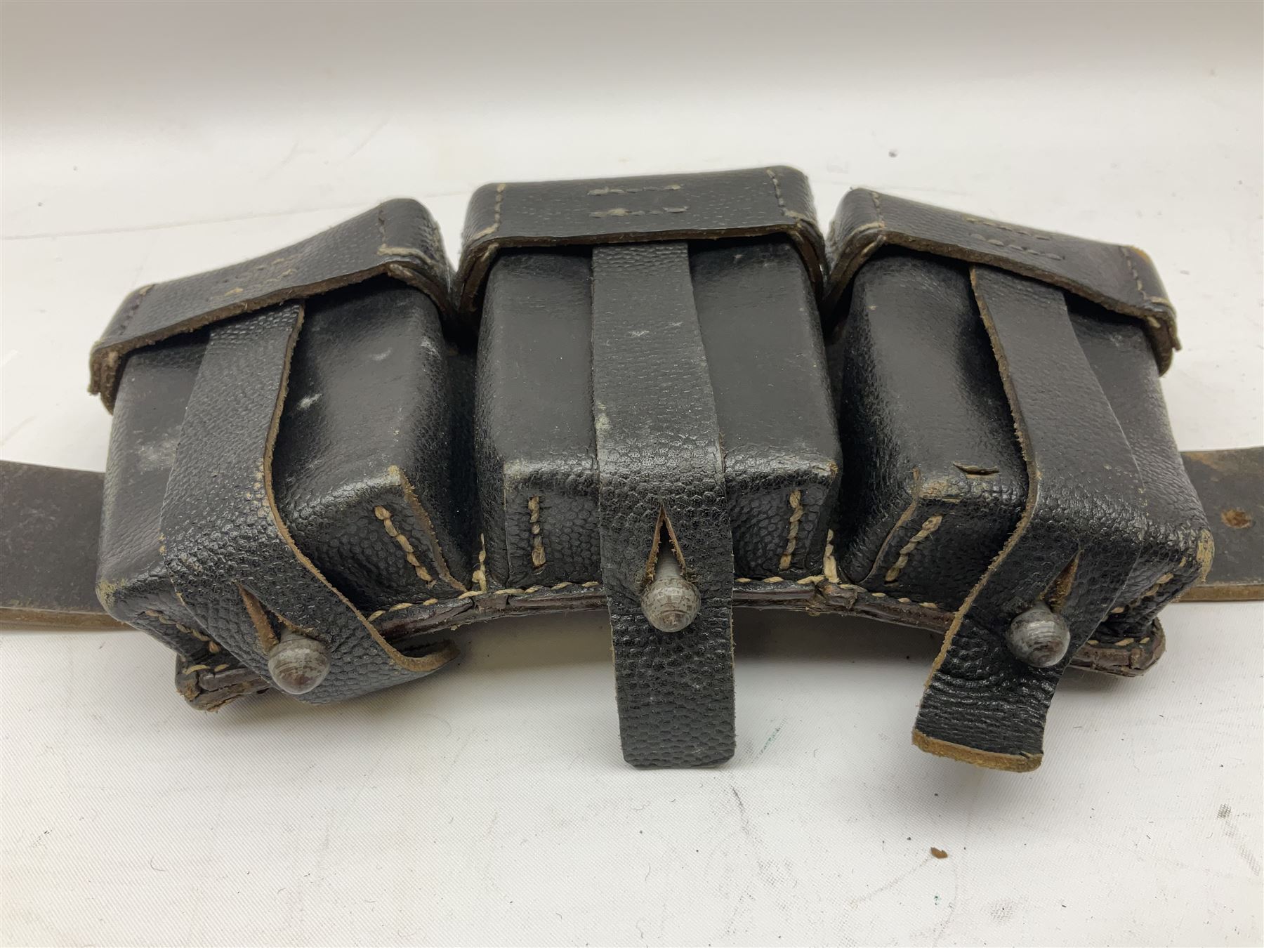WW2 German 'SS' leather belt with six pouches (one containing unused field bandage) and buckle inscribed 'Meine Ehre Heifst Treue'; belt marked 0/0836 0029