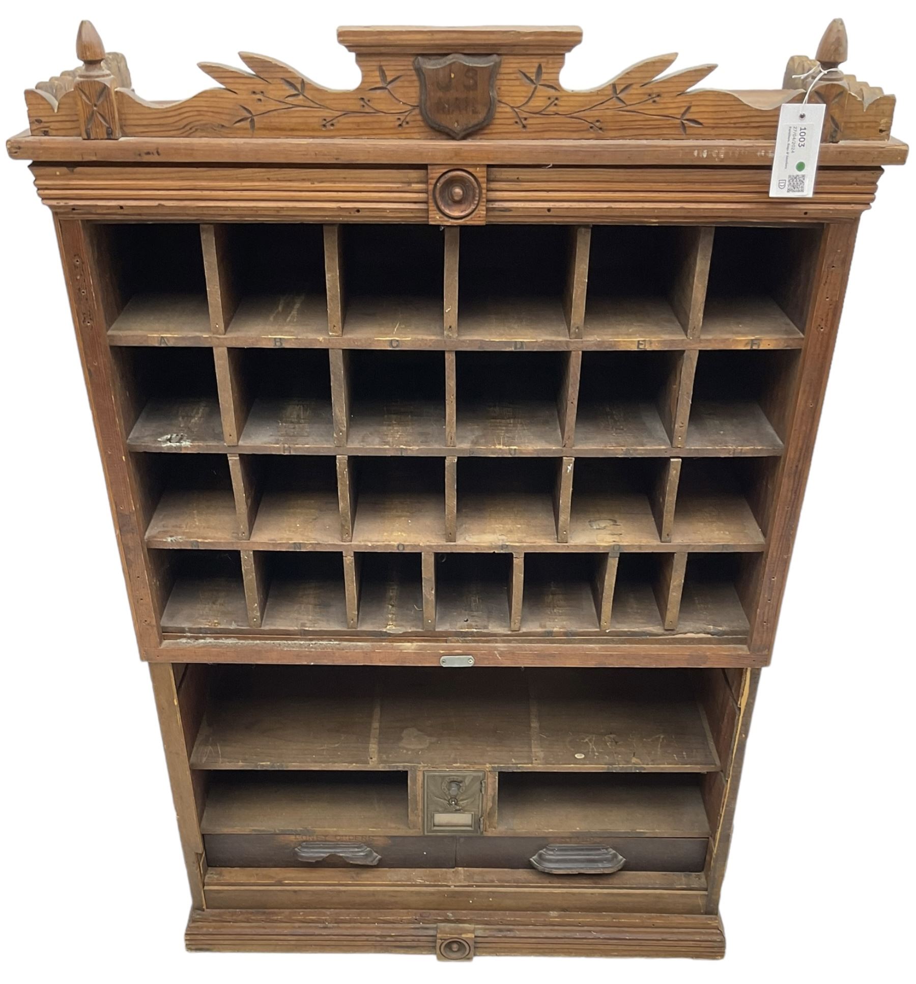 19th century stained pitch pine 'US Mail' pigeonhole unit, raised carved gallery with applied inscribed shield plaque, fitted with twenty five pigeon holes over shelves and correspondence drawers