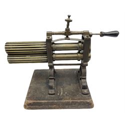 Victorian cuff and collar tabletop mangle, the ribbed brass rollers in a cast iron frame mounted on a wooden base