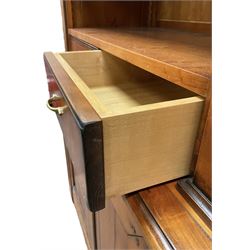 French cherry wood bookcase on cupboard, projecting moulded cornice over three shelves and two small drawers, the cupboard enclosed by two panelled doors flanked by fluted uprights