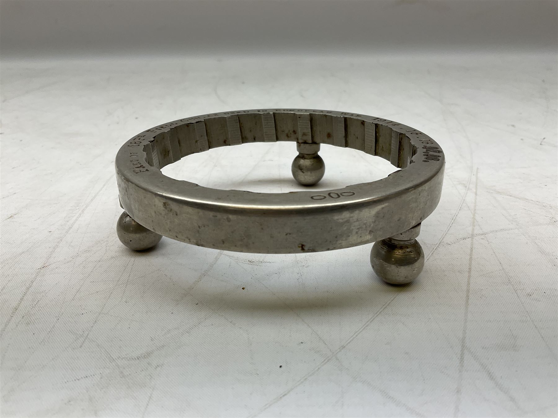 WW1 Trench Art - trivet on three ball feet formed from a section of a gun barrel inscribed 'Part of 18Pr Field Gun, as used in European War 1914.15.16.17.18.' D10cm