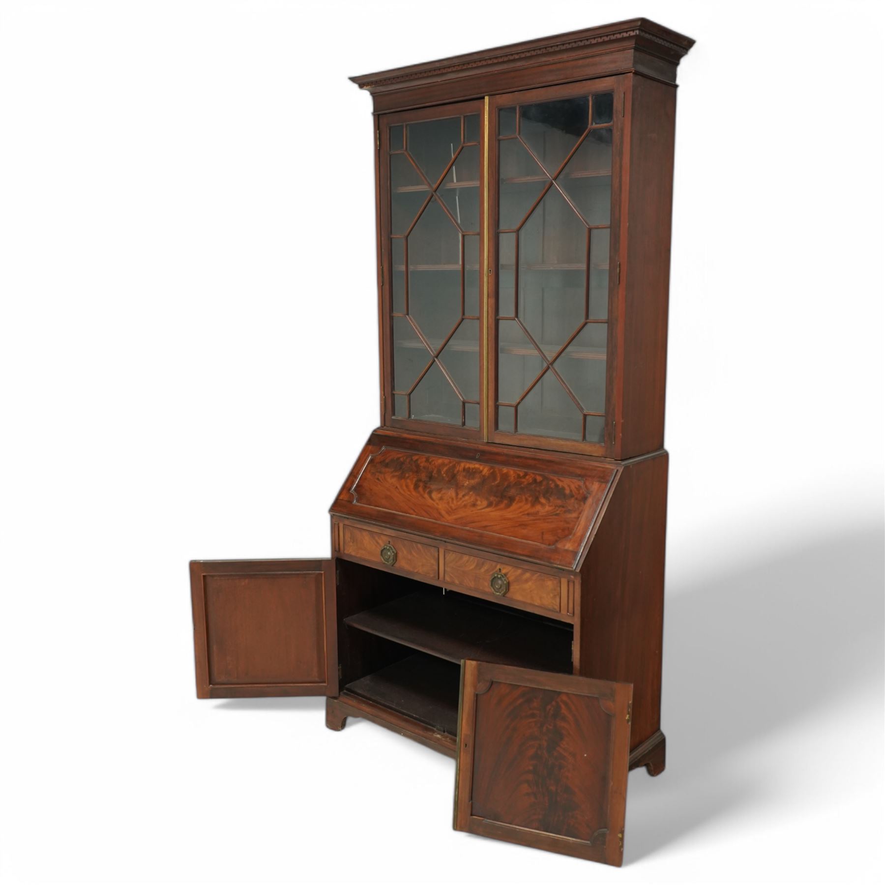 Maples & Co. Edwardian mahogany bureau bookcase, projecting moulded cornice over two astragal glazed door, panelled hinged lid over two drawers and double cupboard, on bracket feet