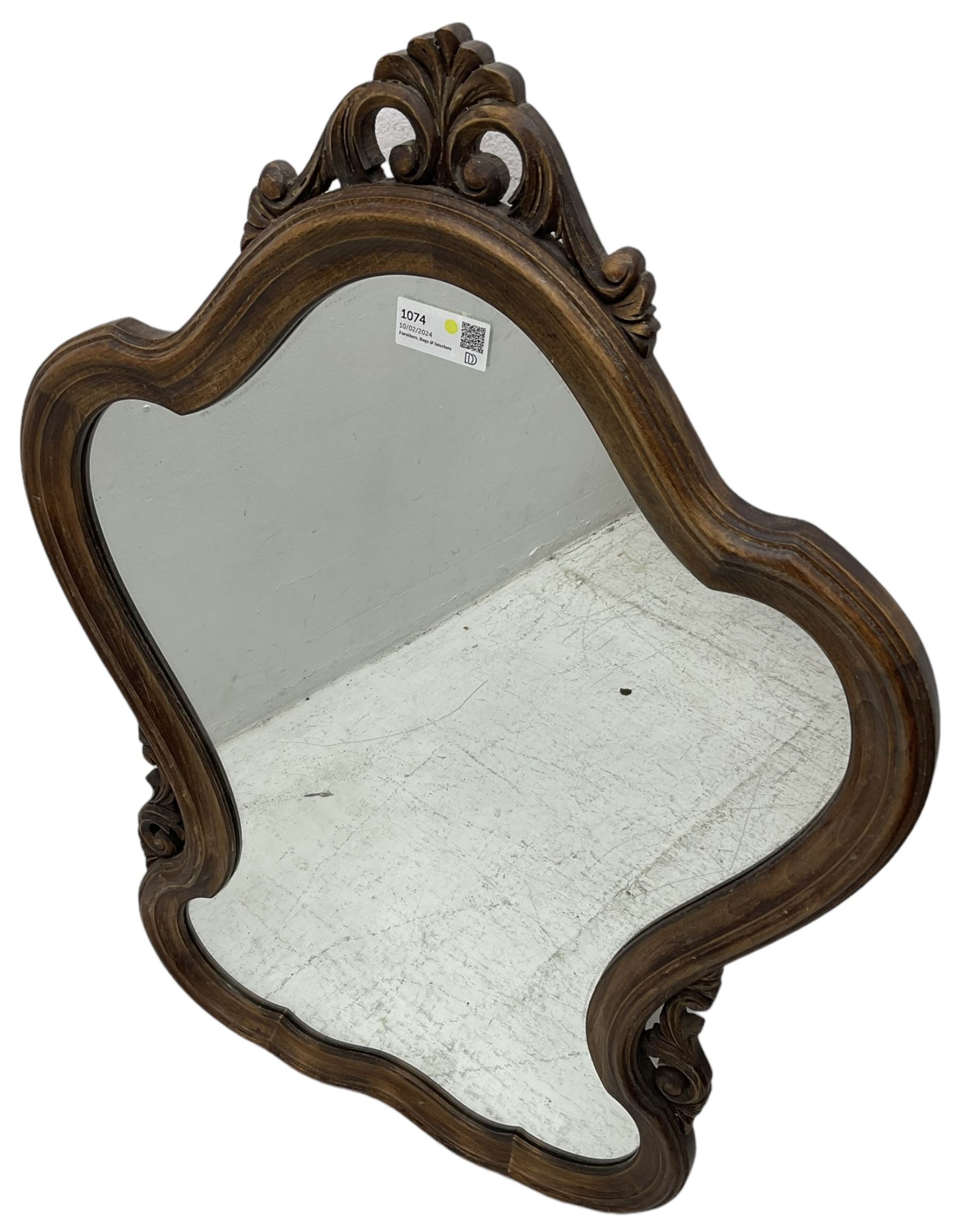 French design stained beech framed wall mirror, shaped and moulded framed with scrolling foliage carved pediment and brackets, plain mirror plate 