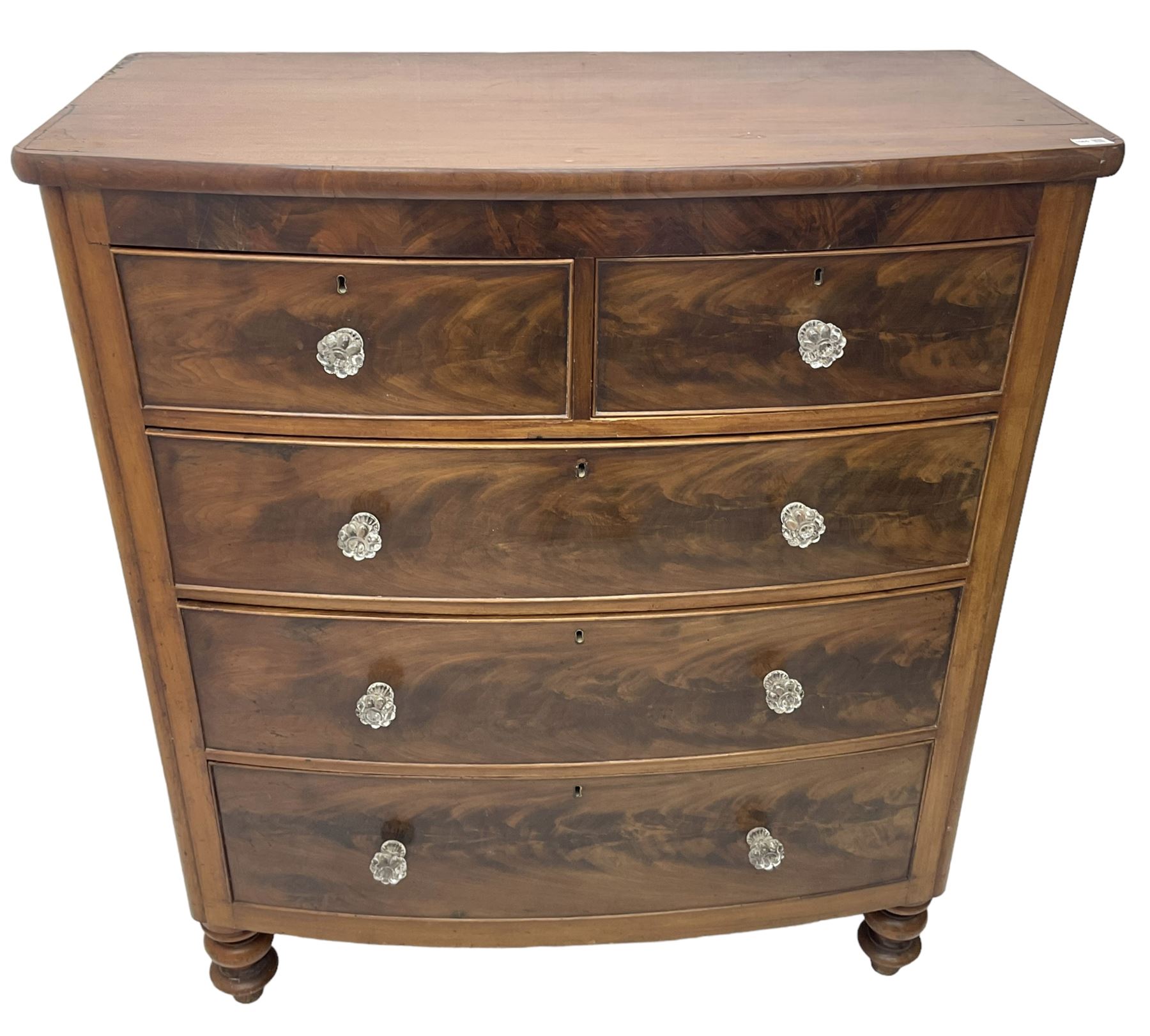 Victorian mahogany bow front chest, fitted with two short over three long graduating cock-beaded drawers, each with glass handles, raised on turned feet