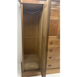Edwardian walnut and ash triple combination wardrobe,  two bevel edge cupboard doors flanking two short and three graduating drawers and two cupboard doors enclosing three linen slides, platform base