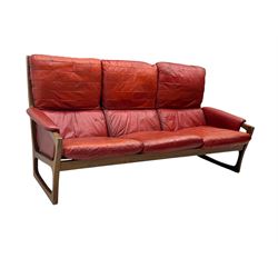 Folke Ohlsson for Gimson & Slater - mid-20th century Danish teak-framed sofa, red leather upholstery with patchwork design, raised on shaped teak side supports