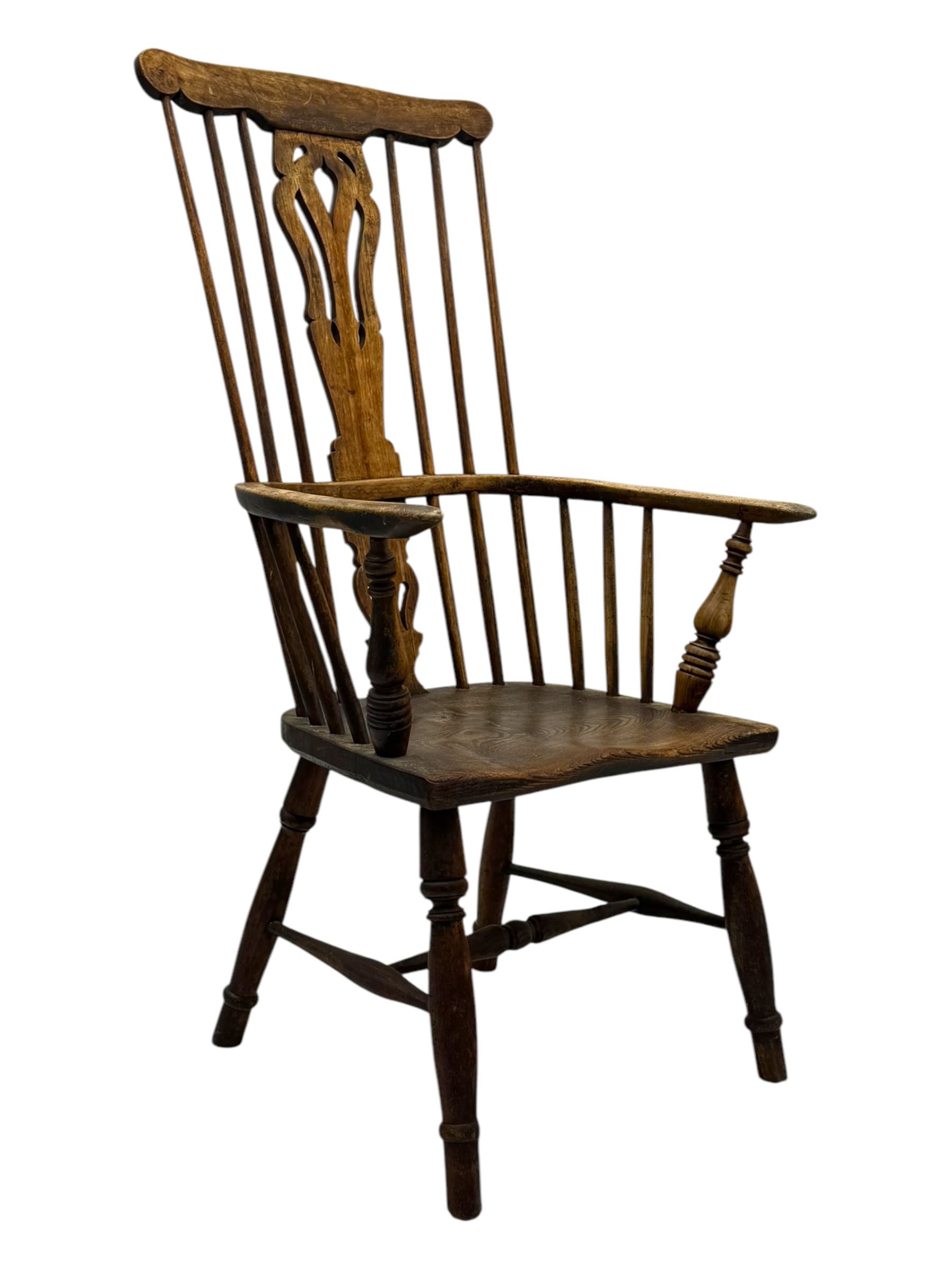 19th century provincial elm and beech Windsor armchair, shaped cresting rail over stick back with pierced and shaped splat, the dished seat on turned supports united by turned stretchers 