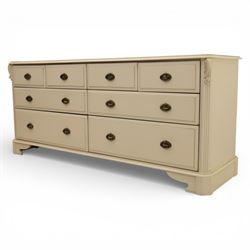 Contemporary French design white painted bedroom suite retailed by Barkers of Northallerton, comprising wide chest fitted with four short and four long drawers with oval brass handles (H 70cm, W 159cm, D 46cm), pair of bedside chests each fitted with three drawers (H 62cm, W 40cm, D 46cm), dressing table fitted with four short drawers and central kneehole with shaped apron (H 79cm, W 131cm, D 46cm) with matching framed wall mounted mirror (H 100cm, W 113cm), and full length standing mirror (H 175cm, W 73cm)